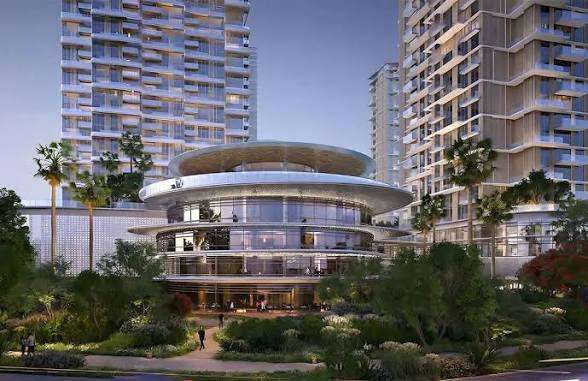  Evening view of the circular amenity building at Serenia District in Jumeirah Islands, Dubai, surrounded by high-rise towers and lush landscaping under artificial lighting .Japanese architectural design  