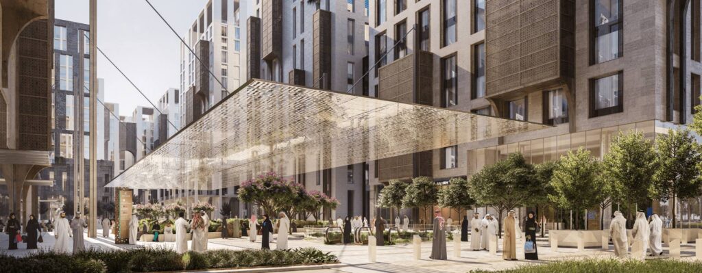 An architectural rendering of a sunny, modern urban pedestrian plaza featuring tall stone buildings with traditional lattice motifs, a large suspended glass or metallic canopy, and people in traditional Arab attire walking among trees and greenery.