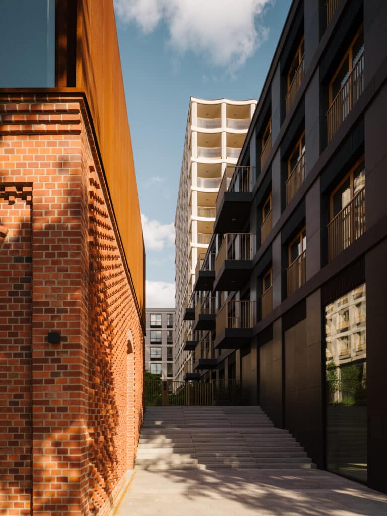 Exterior daytime view of the Nowy Port Bydgoszcz architectural project showing modern building forms and site context.