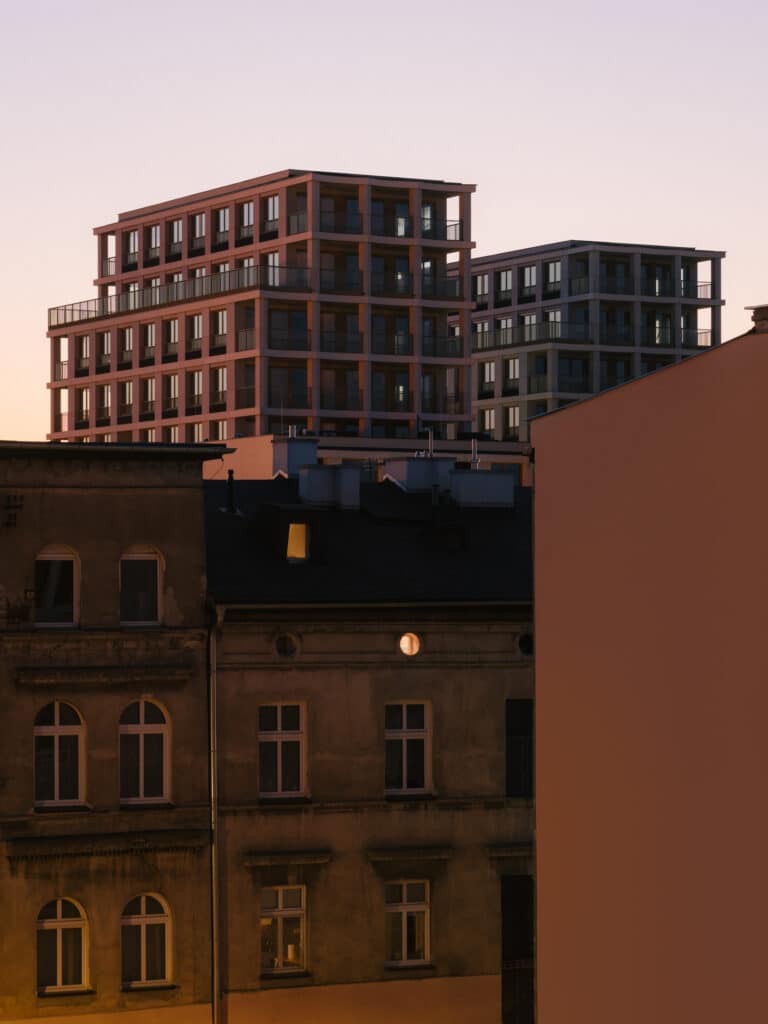 Exterior architectural view of the Nowy Port Bydgoszcz residential development showing contemporary fa&ccedil;ades and urban setting along the waterfront.