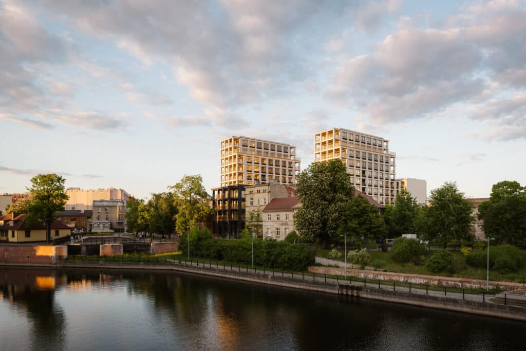 View of the Nowy Port Bydgoszcz residential and mixed‑use development showing contemporary architectural forms and urban environment.