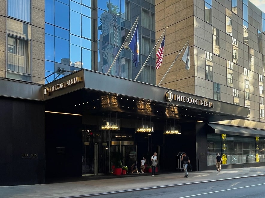 The sleek black entrance canopy of The InterContinental New York Times Square hotel, with the logo and name illuminated