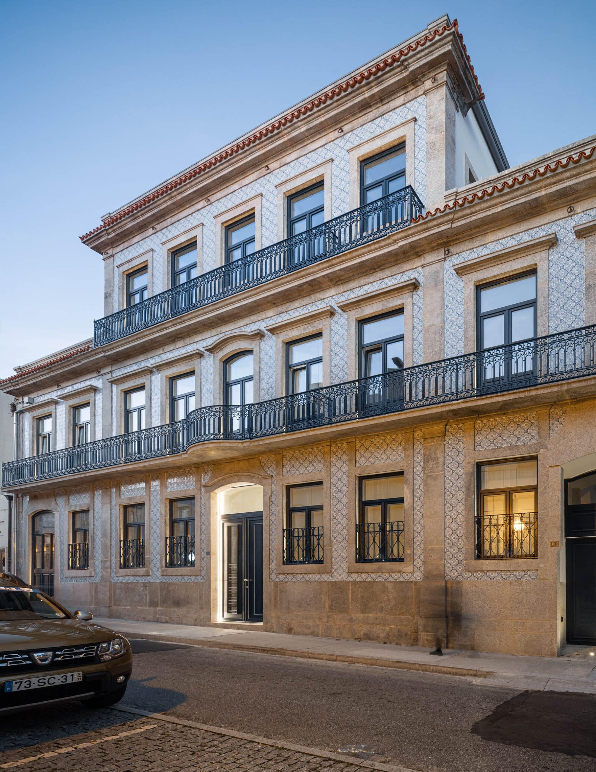 Front facade of Rua de Adolfo Casais Monteiro building showing the four-story structure and restored historic elements.