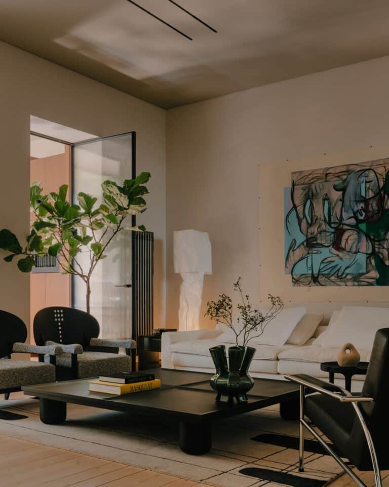 Modern living room showcasing a central dark-tiled fireplace surrounded by natural materials and neutral tones.