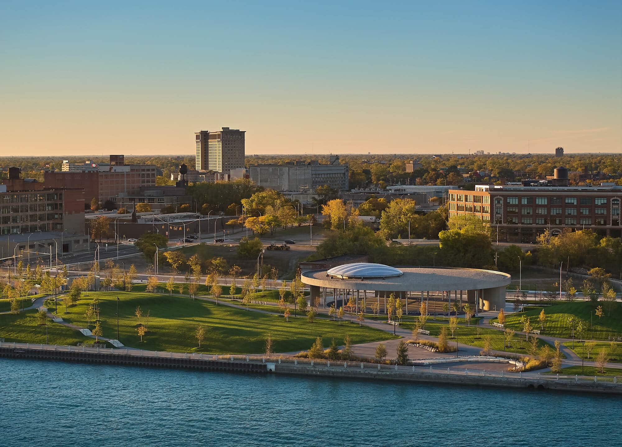Overview of Ralph C. Wilson Jr. Centennial Park showing green spaces, pathways, and riverfront interaction in Detroit.