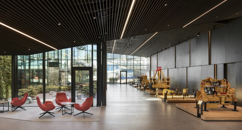 Comprehensive view of FNN Sustainability Center showcasing industrial steel structure, integrated green spaces, multifunctional offices, museum, archive, and green roof emphasizing sustainable design and energy efficiency.