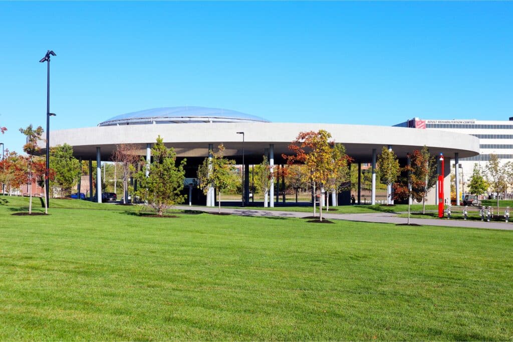 Overview of Ralph C. Wilson Jr. Centennial Park showing green spaces, pathways, and riverfront interaction in Detroit.