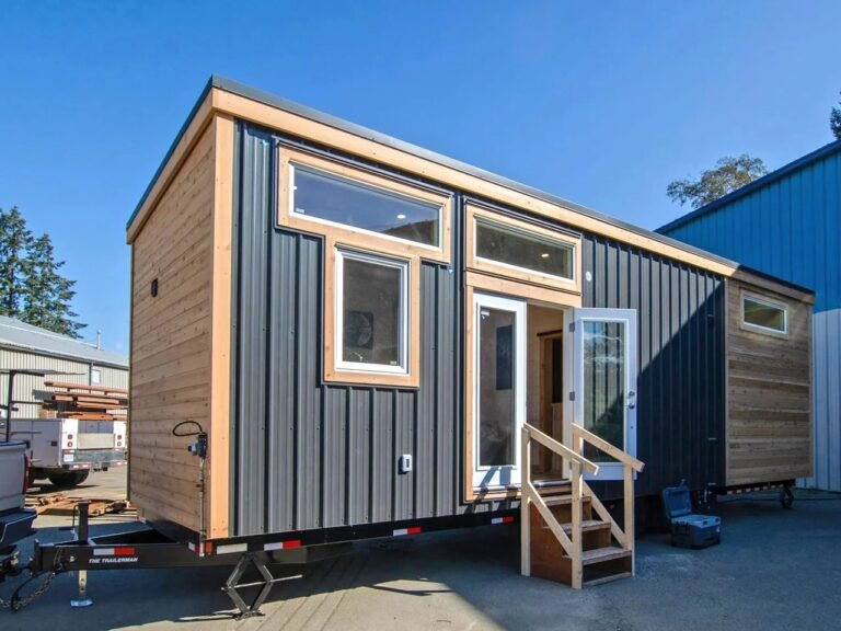 Exterior view of The Thicket sustainable housing project in Priors Hall, showcasing eco-friendly architectural design and integration with natural surroundings.