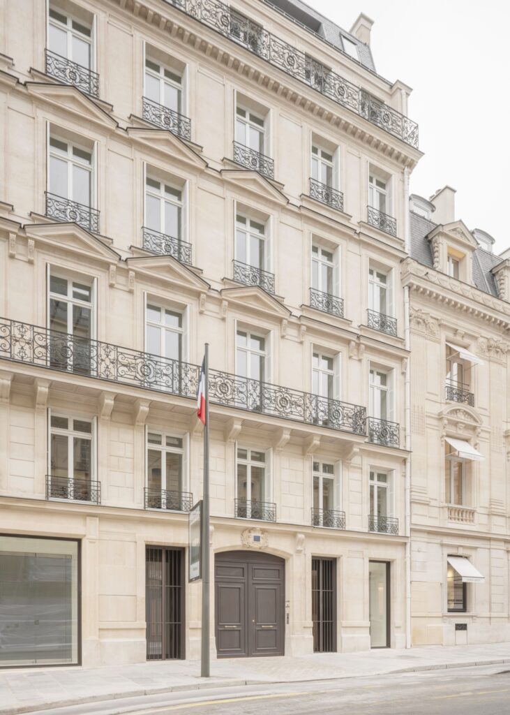 An angled architectural shot of the Francois Ier building facade showing stone textures and classical window alignments.