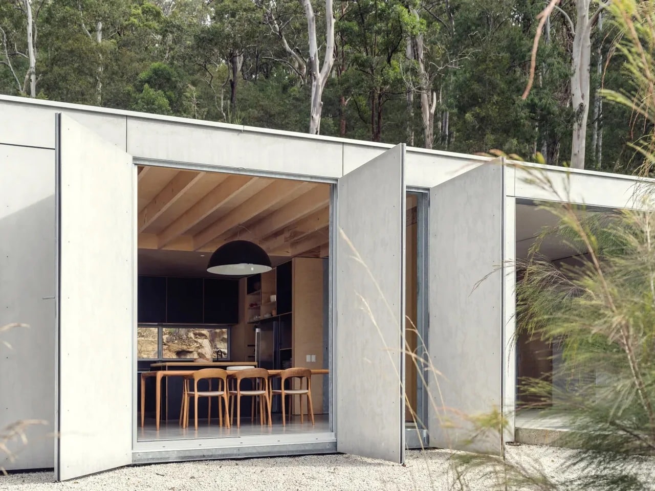 Exterior view of Amongst the Eucalypts holiday home perched among tall eucalyptus trees in New South Wales, highlighting its integration with the forested landscape.