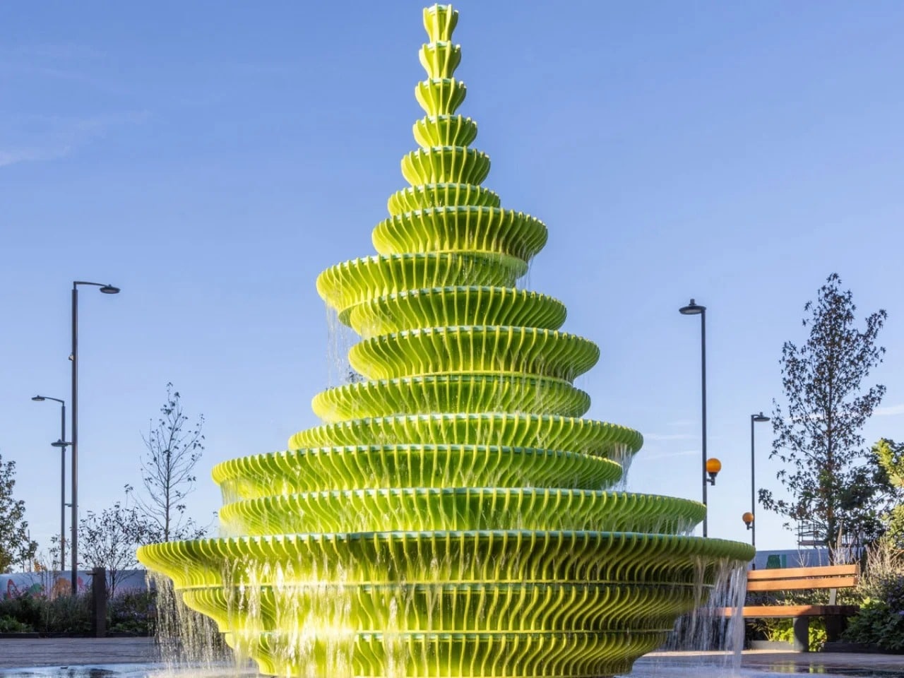 Panoramic view of the contemporary fountain in Brent Cross Town, London, showcasing its asymmetrical design and bright green colors that capture attention in the urban space.