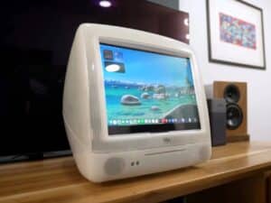 Refurbished Apple iMac G3 featuring original translucent design with modern Mac Mini integration, 4K OLED display, upgraded storage, and enhanced audio system, blending 1990s aesthetics with contemporary performance.