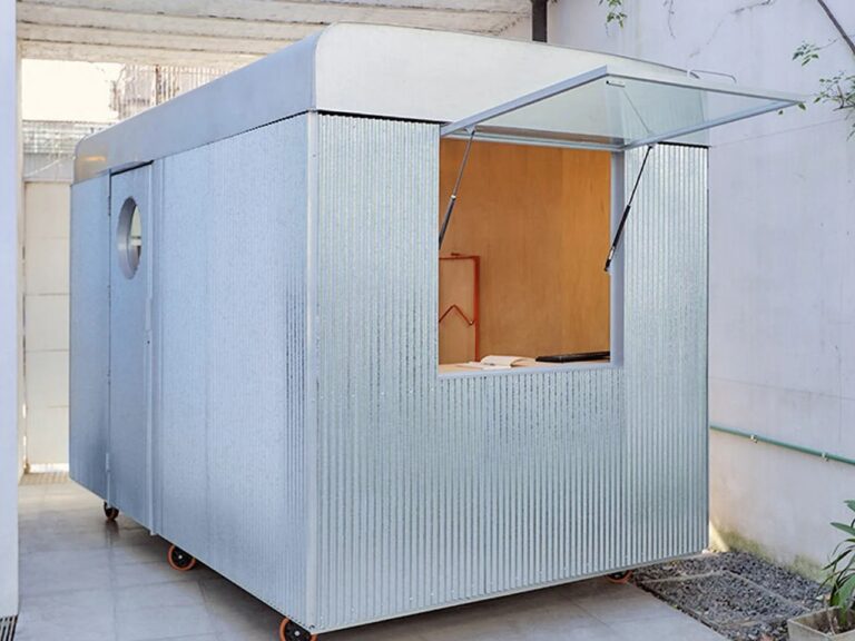 Castillo mobile office stationed in a private courtyard in Buenos Aires, showcasing a compact yet flexible workspace design that adapts to contemporary work patterns.