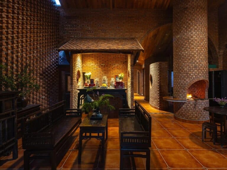 Decorative brick walls and wooden ceilings in Nang House reflecting contemporary reinterpretation of traditional materials.