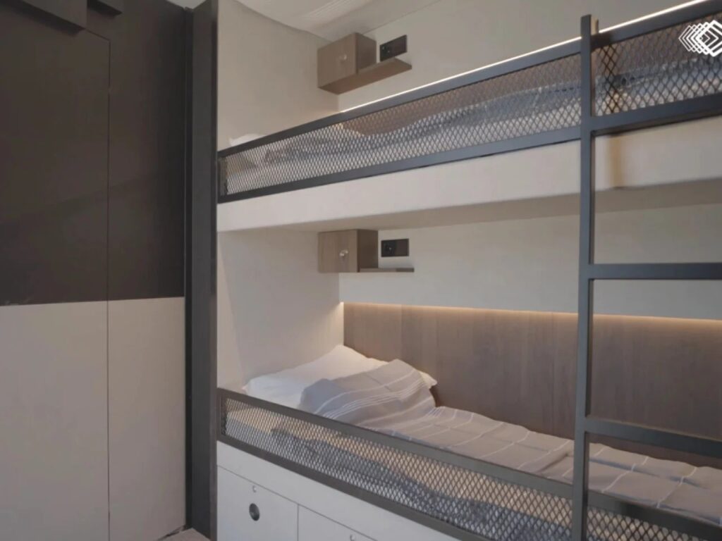 Interior sleeping quarters of the Shiver x Expandable unit showing integrated bunk beds with industrial mesh railings.