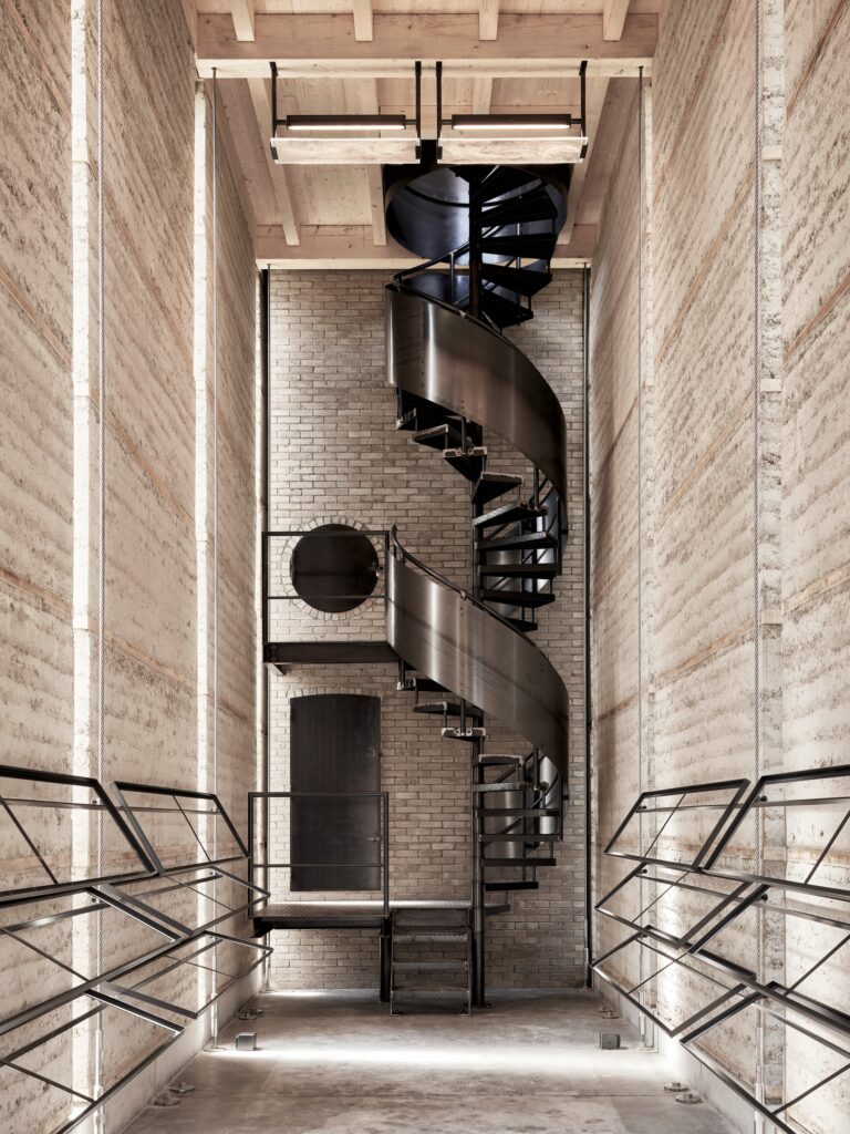 Swiss Brick Museum showcasing traditional manual brick-making, innovative pre-stressed earthen tower, exhibition spaces, and sustainable building techniques for architectural research.