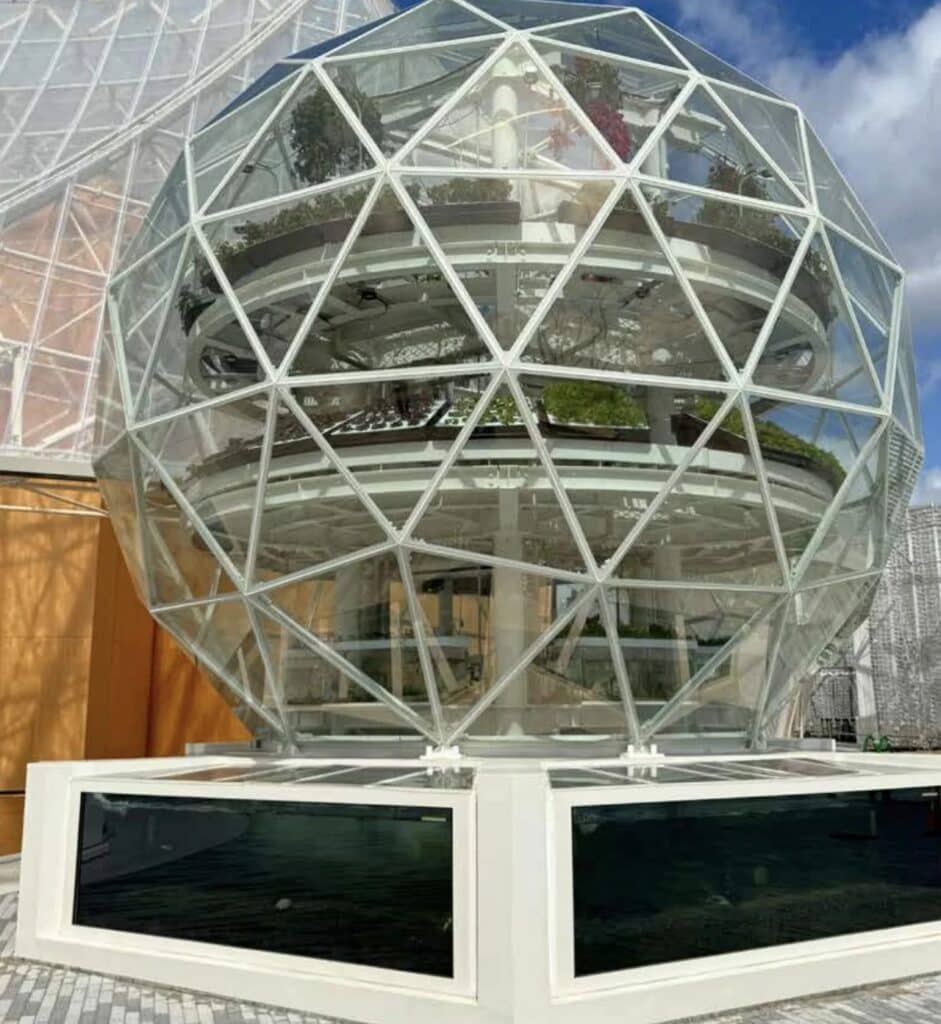 A sustainable vertical farming system showcasing hydroponic crops, modular structures, recycled water loops, and innovative urban food-production technology.