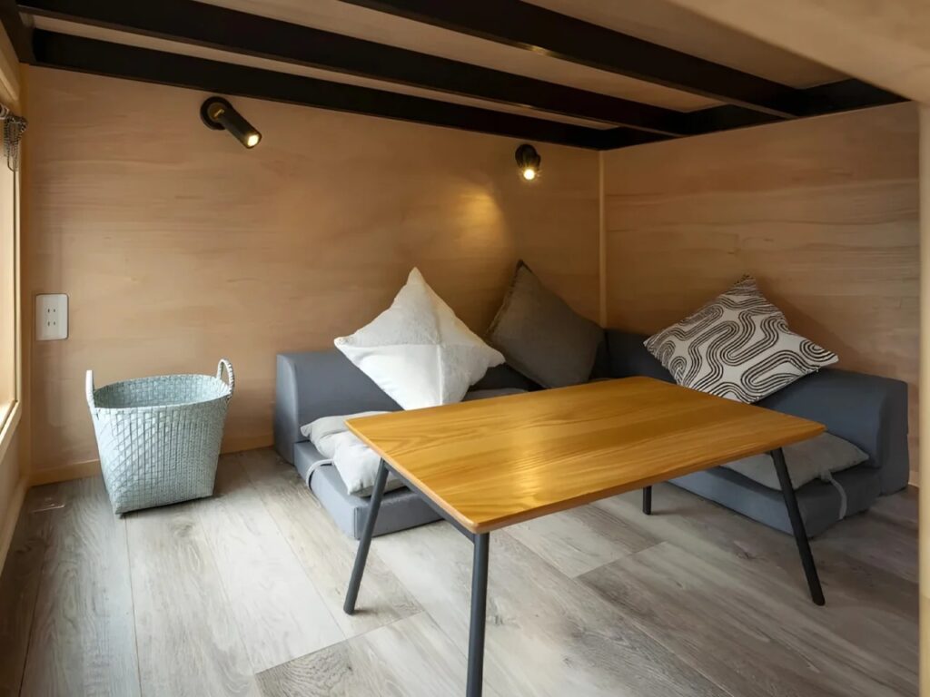 Yamabiko compact house by Ikigai Collective in Nozawa Onsen, illustrating innovative small-space living with symmetrical design, efficient interiors, elevated bedrooms, and integrated kitchen and bathroom.