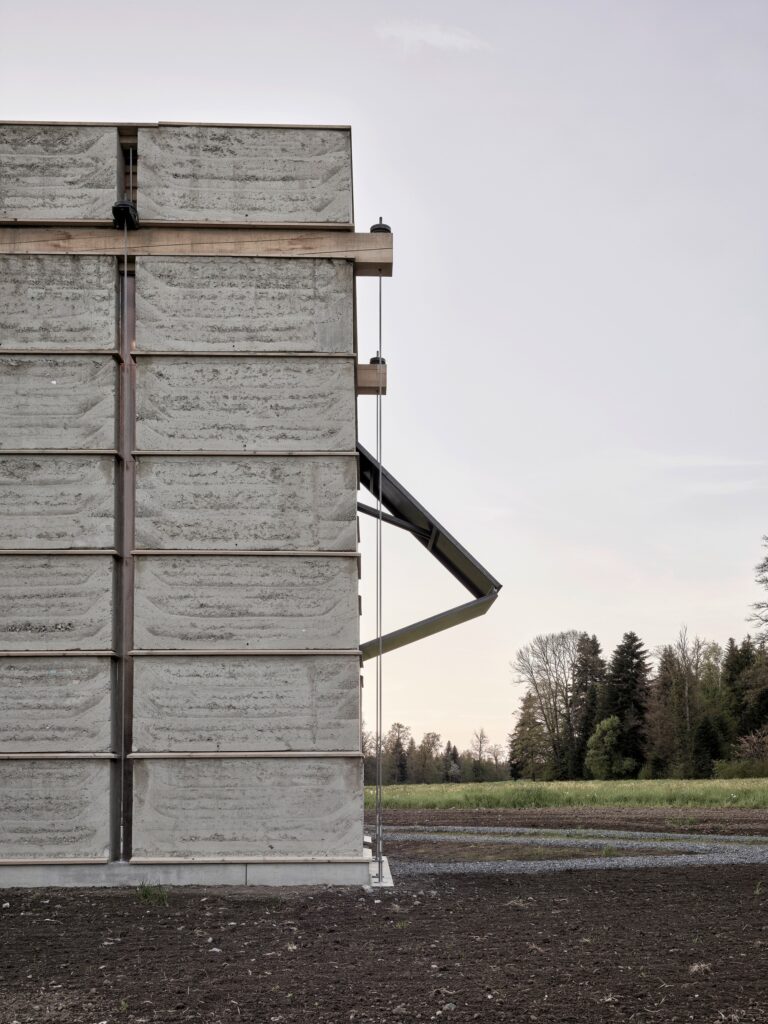 Swiss Brick Museum showcasing traditional manual brick-making, innovative pre-stressed earthen tower, exhibition spaces, and sustainable building techniques for architectural research.