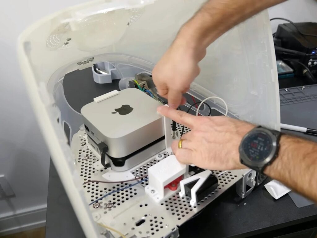 Refurbished Apple iMac G3 featuring original translucent design with modern Mac Mini integration, 4K OLED display, upgraded storage, and enhanced audio system, blending 1990s aesthetics with contemporary performance.