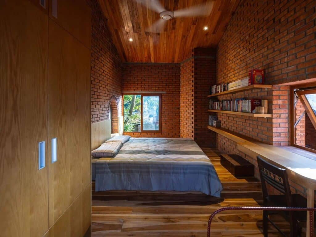 Living spaces of Nang House with framed views of surrounding gardens, enhancing family interaction.