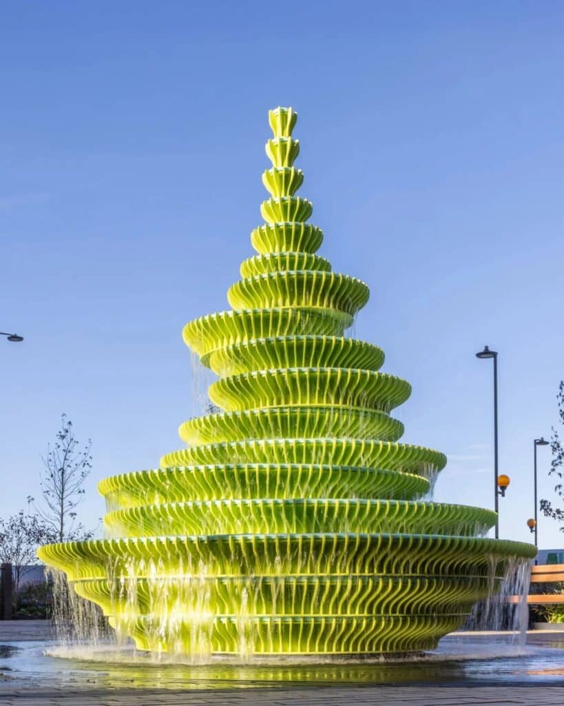 The Fountain in Brent Cross Town, London, is a contemporary and innovative architectural design featuring bright green sculptural panels, unusual angles, and bold colors, combined with frozen water motion to create an interactive visual and sensory experience for visitors, reflecting Neon Studio&rsquo;s philosophy of public art, enhancing local identity and social interaction, while offering a model for redefining fountains in contemporary urban spaces.