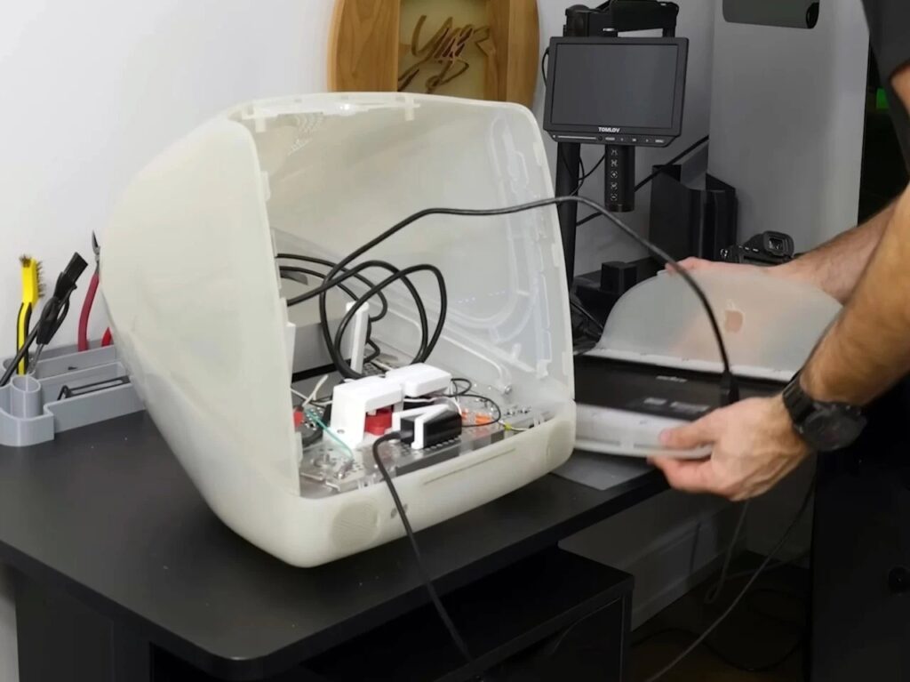 Refurbished Apple iMac G3 featuring original translucent design with modern Mac Mini integration, 4K OLED display, upgraded storage, and enhanced audio system, blending 1990s aesthetics with contemporary performance.