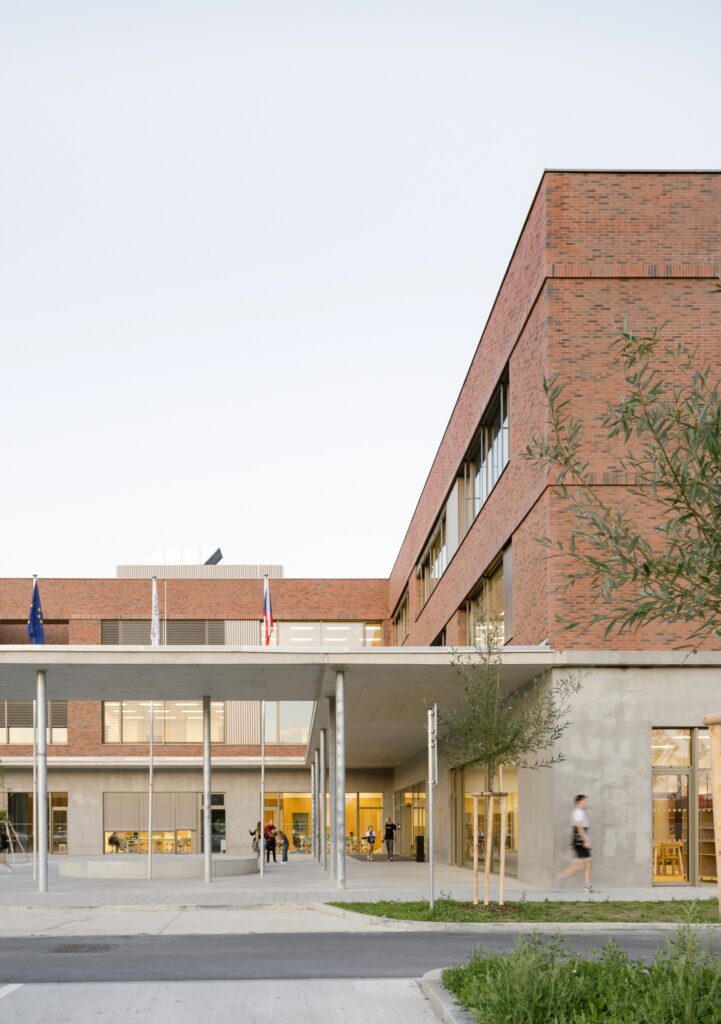 Private courtyard and sports facilities at Cheneh school, separating recreational and educational activities.