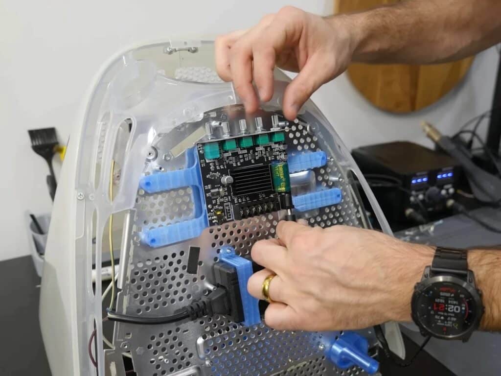 Refurbished Apple iMac G3 featuring original translucent design with modern Mac Mini integration, 4K OLED display, upgraded storage, and enhanced audio system, blending 1990s aesthetics with contemporary performance.