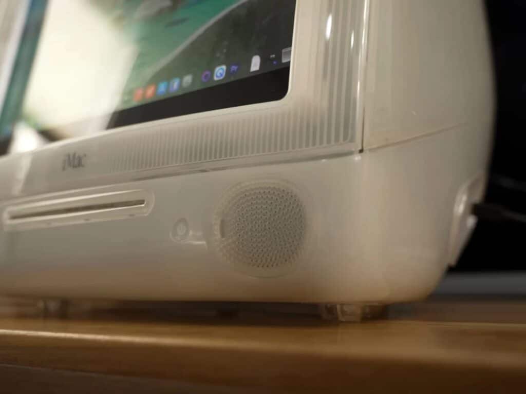 Refurbished Apple iMac G3 featuring original translucent design with modern Mac Mini integration, 4K OLED display, upgraded storage, and enhanced audio system, blending 1990s aesthetics with contemporary performance.