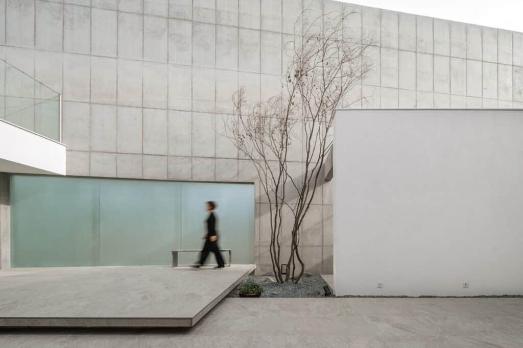 Comprehensive view of a modern family house design integrating interior and exterior spaces, private terraces, landscaped courtyards, natural lighting, and family-oriented living areas.