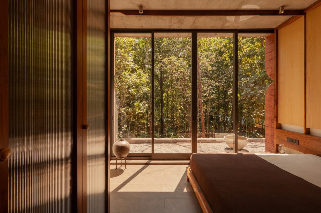 Sumish residence in Bayanur, Kerala, exemplifying the integration of local cultural heritage, traditional architecture, natural materials, open-plan interiors, and sustainable design strategies, harmonizing indoor and outdoor spaces while reflecting the region's spiritual and environmental context.