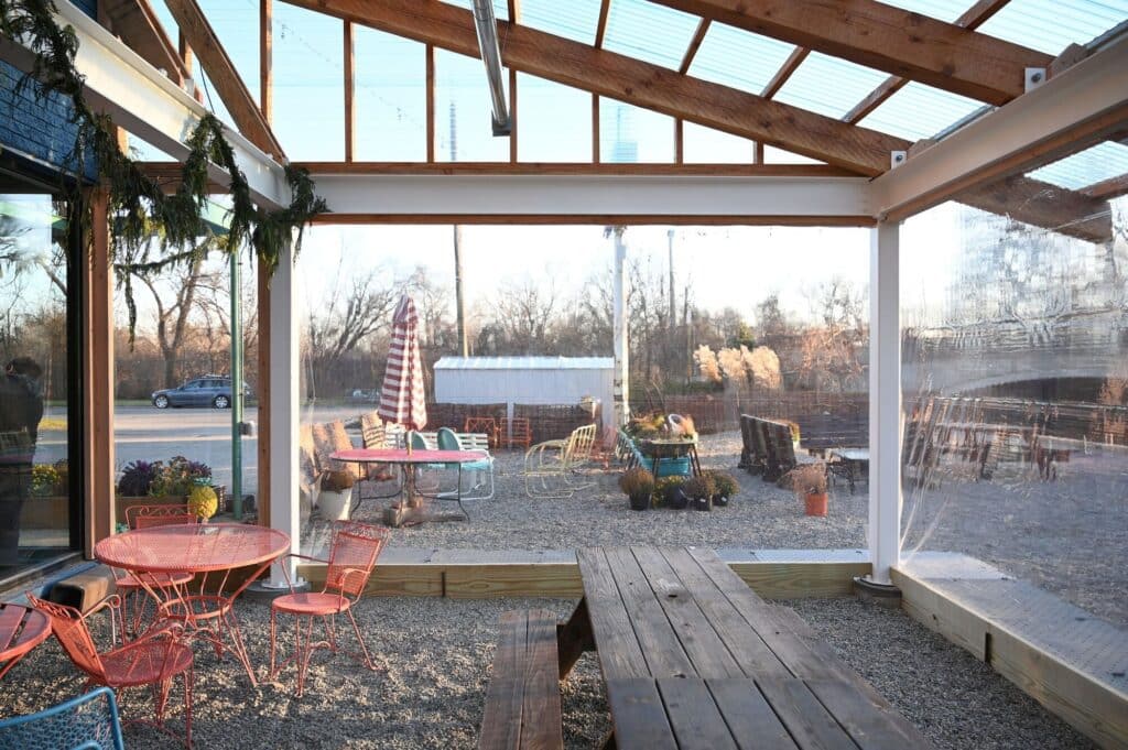 Big Roof architectural project in Detroit combines flexible open-air spaces, seasonal dining areas, wavy roof design, transparent structure, and natural environmental integration.