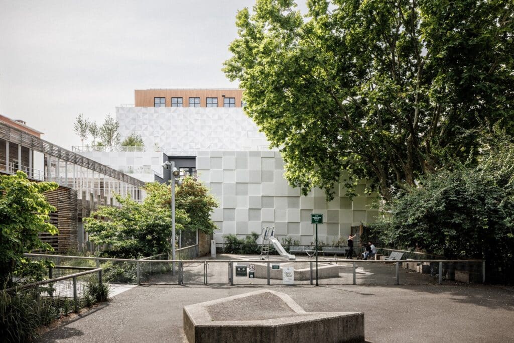 42UP vertical campus in Paris showcasing innovative architectural solutions including suspended bridge structures, perforated metal facades, open-plan educational floors, integrated urban ecosystem with NOC42, and vertical art installations enhancing student experience.