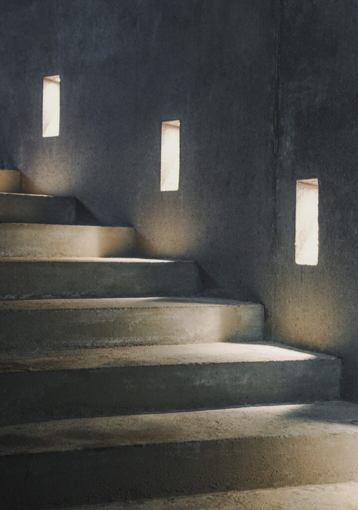 Kalleb&auml;cks Terrasser architectural project exploring the interaction between sculptural building forms, rocky terrain, innovative materials, eco-friendly concrete, and unique interior lighting, offering a comprehensive experience of transitional spaces between nature and architecture.