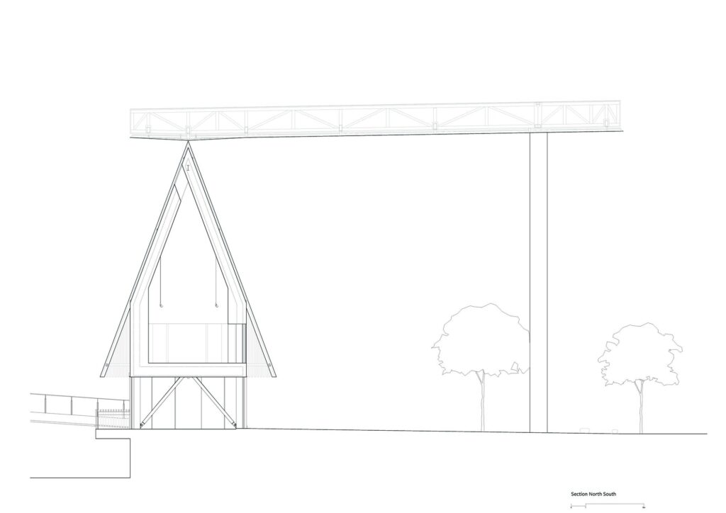 Exterior street view of the George Street Community Building, a dark, angular structure with a perforated roof, set against modern skyscrapers and adjacent to a public staircase.