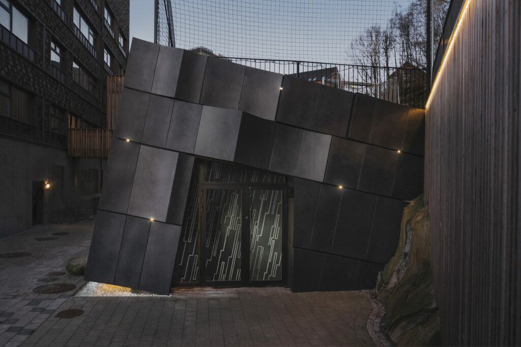 Kalleb&auml;cks Terrasser architectural project exploring the interaction between sculptural building forms, rocky terrain, innovative materials, eco-friendly concrete, and unique interior lighting, offering a comprehensive experience of transitional spaces between nature and architecture.