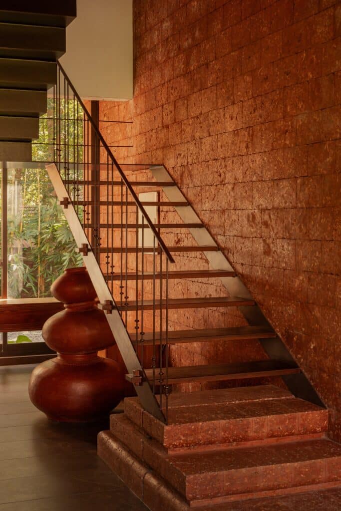 Sumish residence in Bayanur, Kerala, exemplifying the integration of local cultural heritage, traditional architecture, natural materials, open-plan interiors, and sustainable design strategies, harmonizing indoor and outdoor spaces while reflecting the region's spiritual and environmental context.