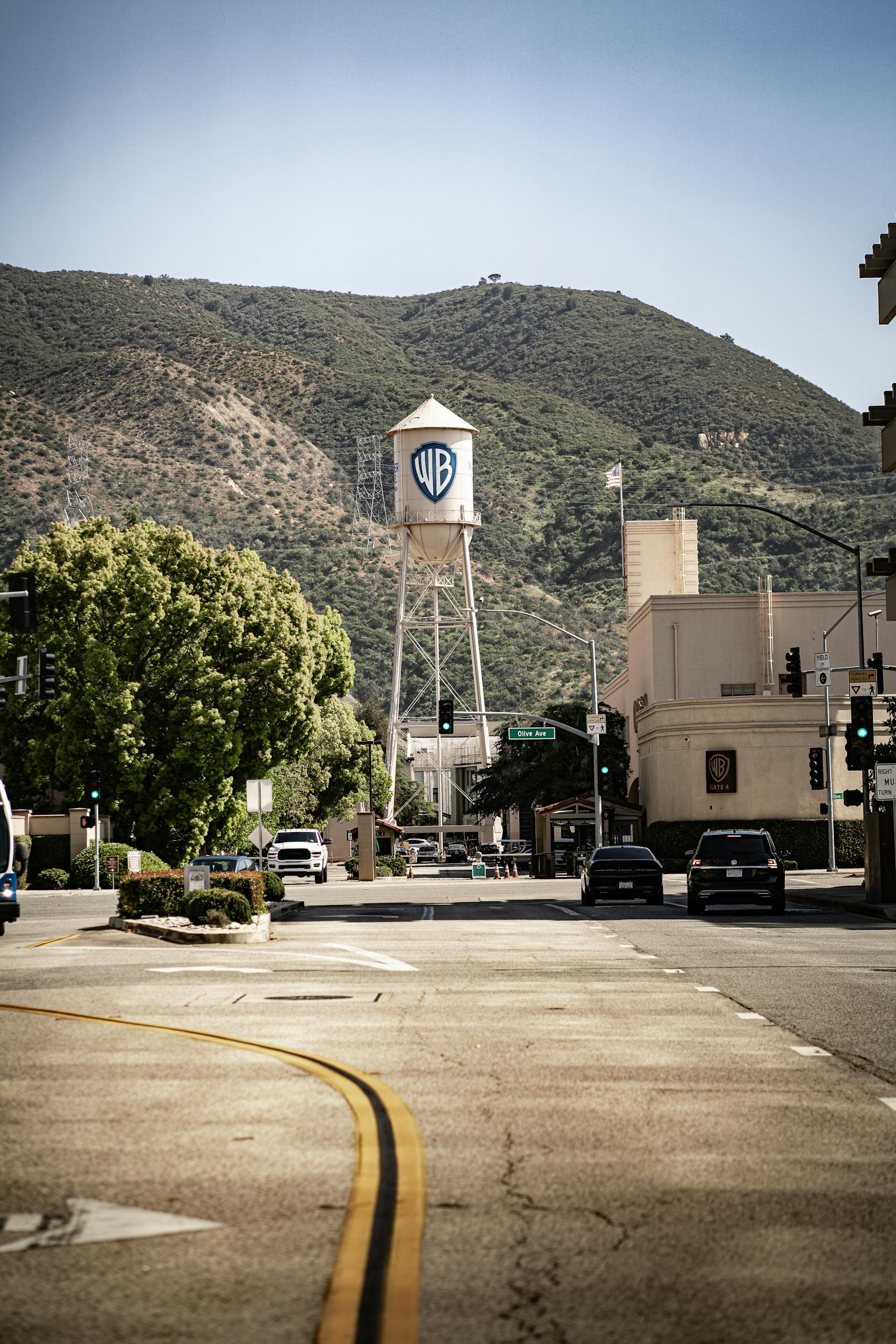 View of the historic Warner Bros water tower set against Los Angeles street backdrop.