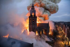 Vondelkerk church burning with flames and smoke rising into the night sky during the New Year fire