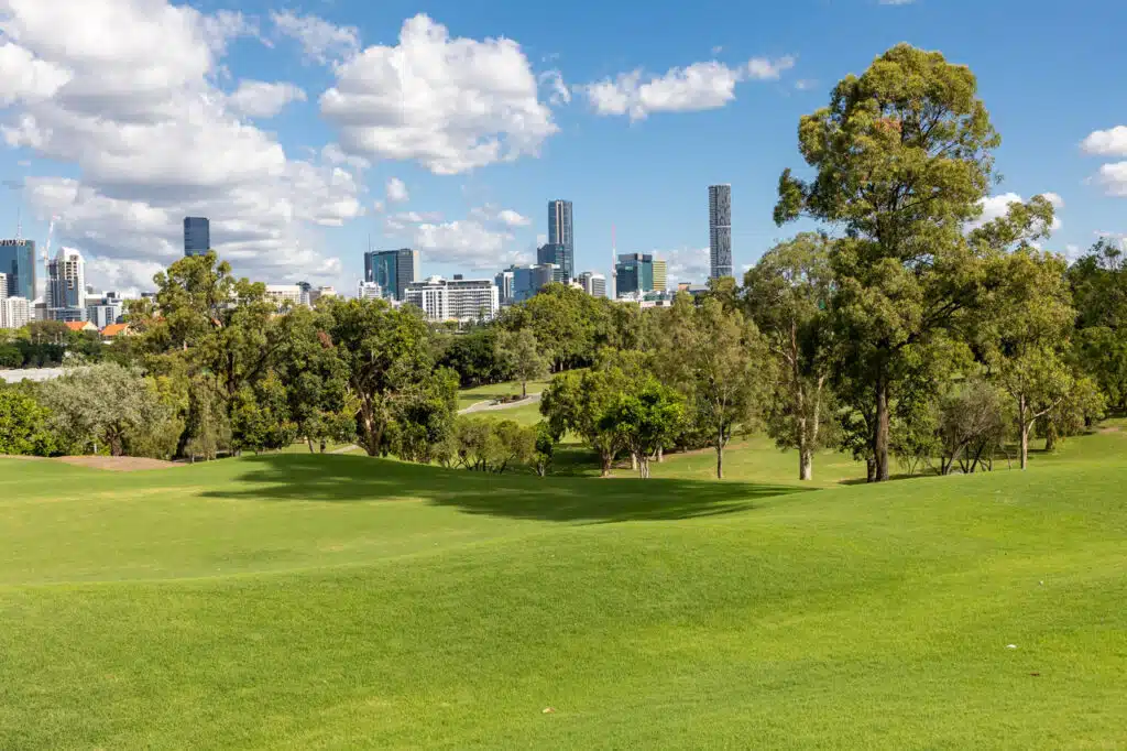 Victoria Park’s green expanse with Brisbane skyline in background, site of the future Sustainable Olympic Stadium.