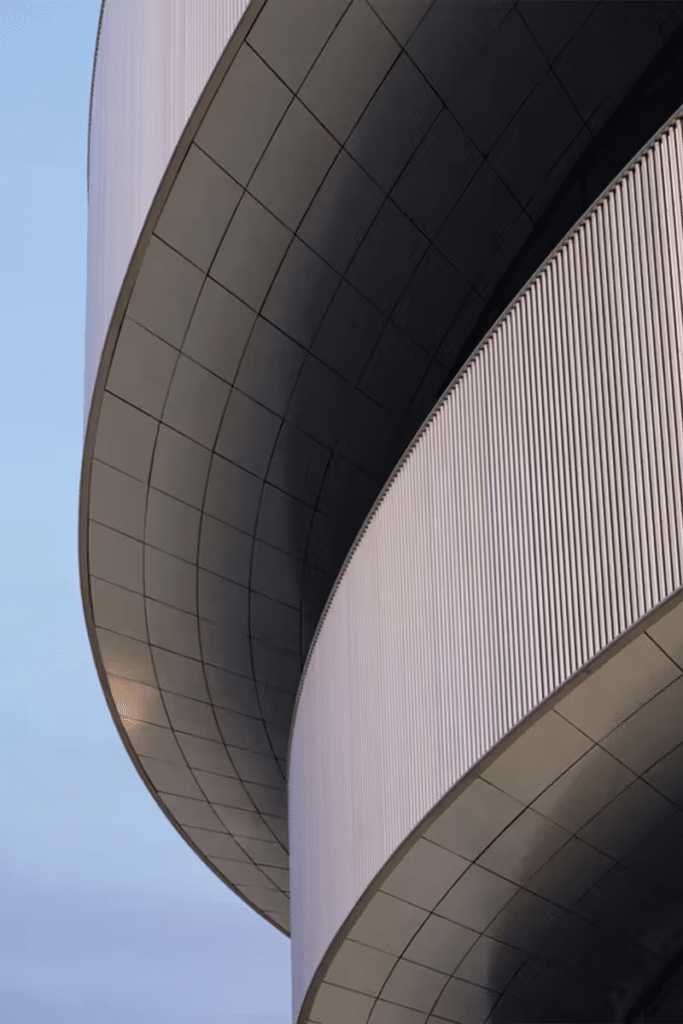 The grand main entrance of the Milano Santa Giulia Arena, with wide steps leading up to the podium and the floating ring facade designed by David Chipperfield Architects.