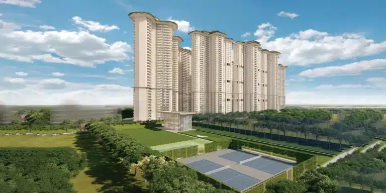 Aerial view of a branded residential tower complex in Gurgaon with curved forms and landscaped grounds.