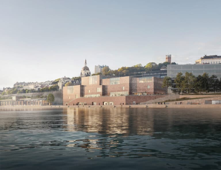 Nobel Center Stockholm 2026 exterior view showing interlocking brick volumes along the Slussen waterfront with historic cityscape in background