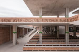 Detailed view of the patterned terracotta brick facade of the Zando Central Market, showcasing the moucharabieh-inspired ventilation screens.