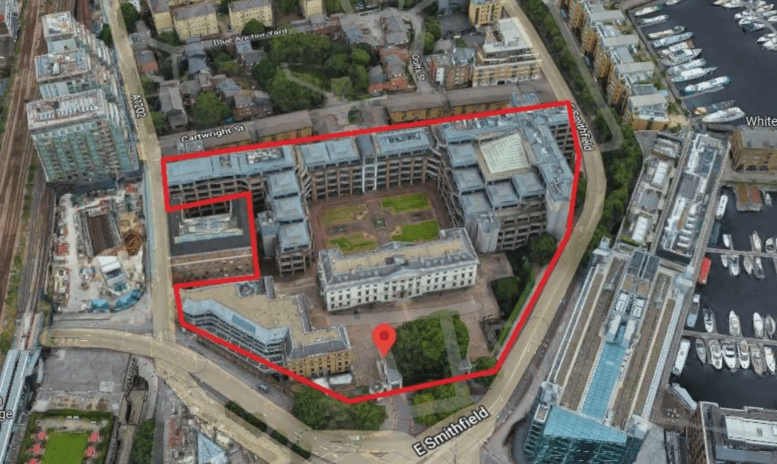 An aerial view of the Royal Mint Court redevelopment site, outlined in red, located next to St Katharine Docks.