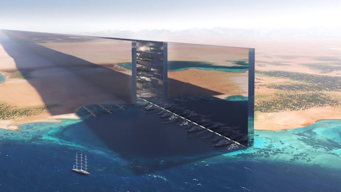 Wide aerial render of The Line's mirrored architecture in Neom, illustrating the project's original scale before its strategic shift.