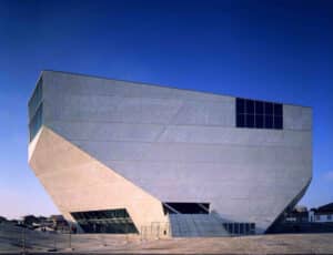 The faceted white concrete exterior of the Casa da Musica by OMA, standing as a sculptural landmark in Porto.