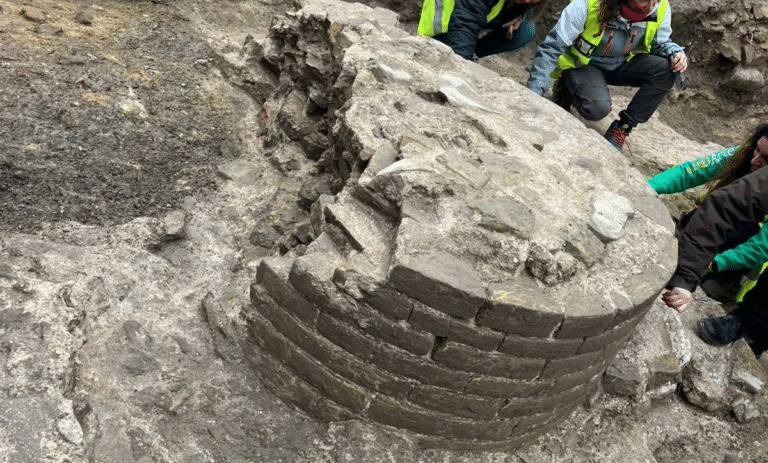 Close-up of an ancient column's brick base at the Fano archaeological site, part of a newly discovered Roman public building attributed to Vitruvius