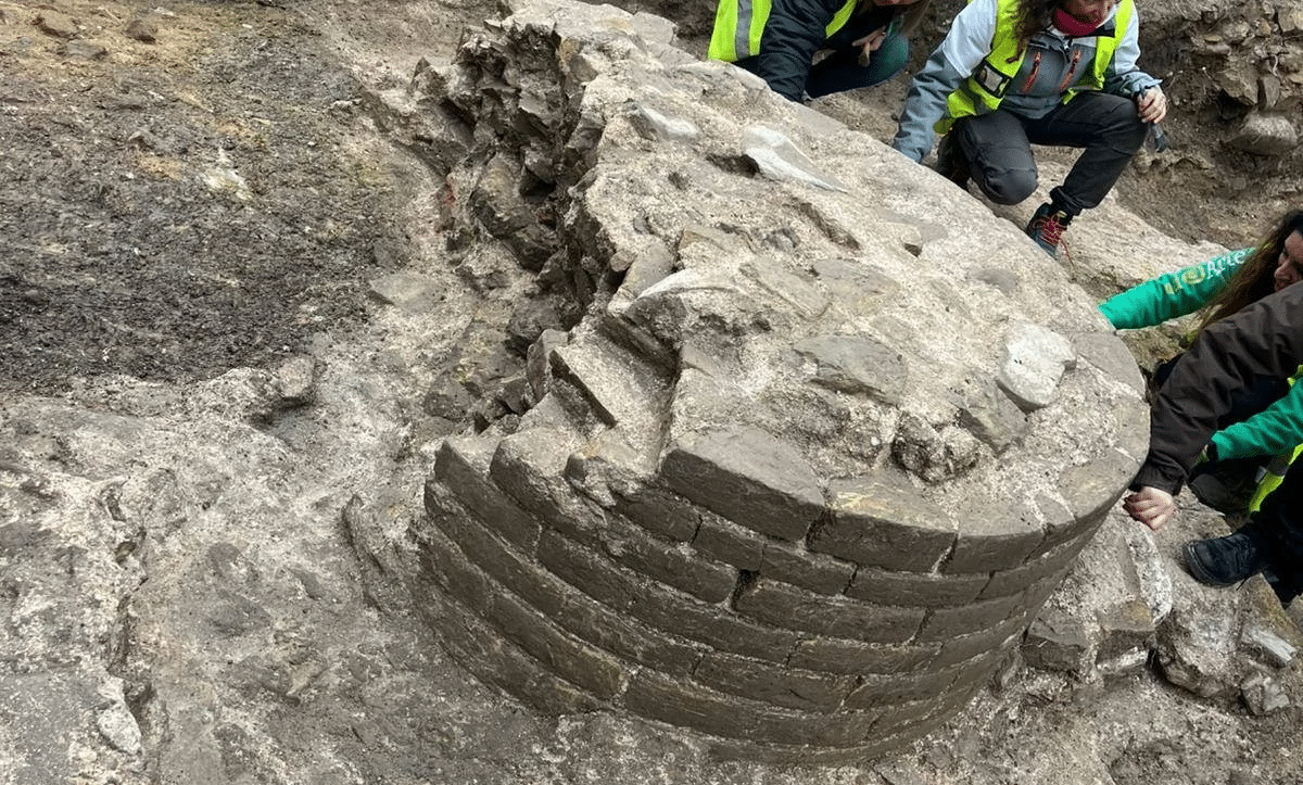 Close-up of an ancient column's brick base at the Fano archaeological site, part of a newly discovered Roman public building attributed to Vitruvius